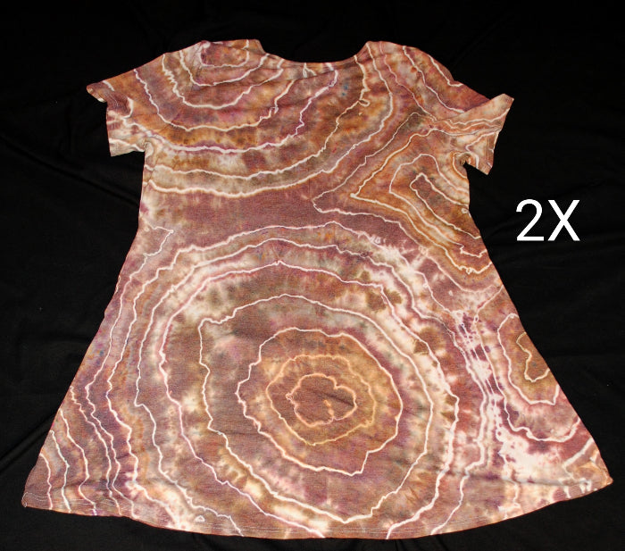 A short-sleeve A-line dress with a brown, pink, and cream agate stone pattern, laid flat on a black background with a white letter '2X' on the right side.