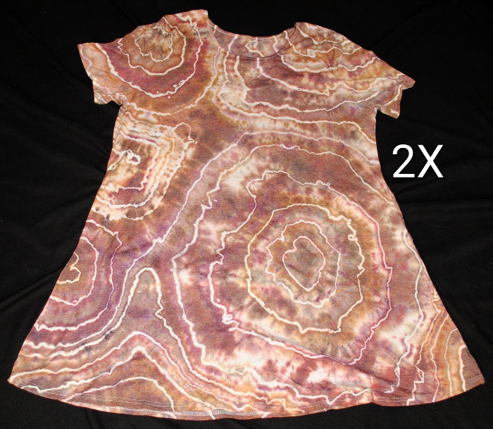 A short-sleeve A-line dress with a brown, pink, and cream agate stone pattern, laid flat on a black background with a white letter '2X' on the right side.