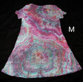A short-sleeve A-line dress with a vibrant agate slice tie-dye pattern in pink, teal, and white, shown against a solid black background with a size label 'M' on the right.