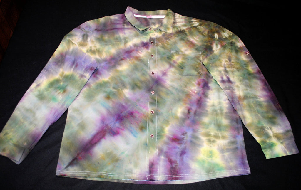 A long-sleeve button-up shirt with a multicolor tie-dye pattern in purple, green, yellow, and white, laid flat on a black background.
