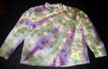 A long-sleeve button-up shirt with a multicolor tie-dye pattern in purple, green, yellow, and white, laid flat on a black background.