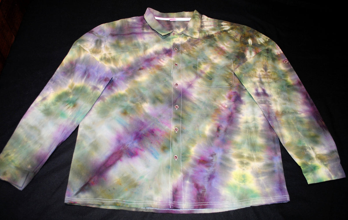 A long-sleeve button-up shirt with a multicolor tie-dye pattern in purple, green, yellow, and white, laid flat on a black background.