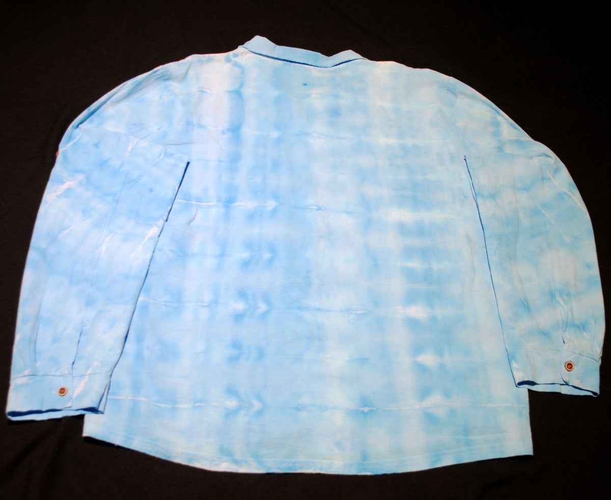 A light blue and white tie-dye long-sleeve shirt laid flat on a black background.