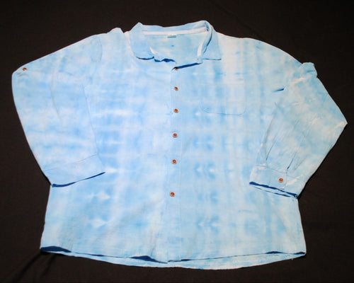 A light blue tie-dye long-sleeve button-up shirt laid flat on a black background.